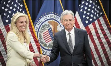  ?? — AFP ?? Showing commitment: Powell (right) is congratula­ted by Fed vice-chairman Lael Brainard after he took the oath of office for his second term. The central bank is determined to restore price stability as it prepares to raise rates further next month.