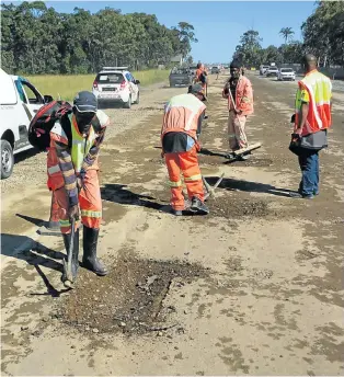  ?? Picture: MIKE LOEWE ?? QUICK FIX: Road workers patch up storm damage to temporary lanes in the Eastern Cape. The government’s Expanded Public Works Programme has been likened to sticking a plaster on unemployme­nt