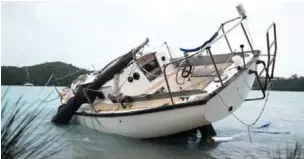  ?? — AP ?? ST GEORGES, Bermuda: A sailboat lays damaged on the shore of Ferry Reach after breaking free from its mooring after the passing of Hurricane Nicole on Thursday.