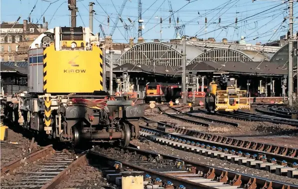  ?? NETWORK RAIL. ?? A Kirow crane brings new track panels for installati­on at the southern end of Newcastle Central station on January 8.