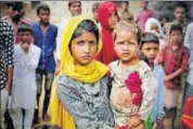  ?? AP PHOTO ?? Sahila Khan, daughter of Rakbar Khan, carries her sibling Manseera at their home in Kolgaon village.