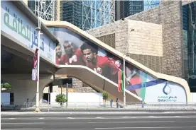  ?? Photograph: Simon Holmes/NurPhoto/Shuttersto­ck ?? Qatar’s Akram Afif is featured on a World Cup 2022 poster outside West Bay Qatar Energy metro station in Doha.