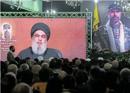  ?? /Reuters ?? Sending messages: Lebanon's Hezbollah leader Sayyed Hassan Nasrallah appears on a screen as he gives a televised address at a memorial ceremony to mark a week since the killing of Wissam Tawil, a commander of Hezbollah's elite Radwan forces.