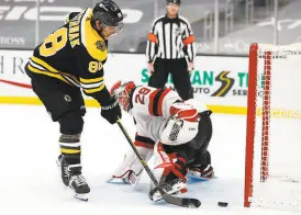  ?? Maddie Meyer / Getty Images ?? Bruins wing David Pastrnak scores a shootout goal against Mackenzie Blackwood during Boston’s win at TD Garden.