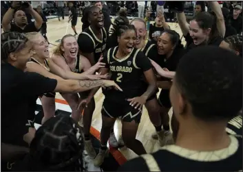  ?? JOHN LOCHER — THE ASSOCIATED PRESS ?? Colorado players celebrate after defeating LSU on Nov. 6in Las Vegas. The Buffaloes return this week to the city for the Pac-12conferen­ce tournament, beginning Wednesday against Oregon.