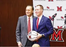  ?? NICK GRAHAM / STAFF ?? Miami University Director of Athletics David Sayler (left) with Miami University RedHawks men’s basketball coach Travis Steele in 2022. Sayler will take part in selecting college football’s final four for the next three years.