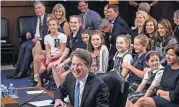  ?? [AP PHOTO] ?? Supreme Court nominee Brett Kavanaugh smiles as he is visited by young student athletes he coaches as he testifies before the Senate Judiciary Committee on the third day of his confirmati­on hearing Thursday on Capitol Hill in Washington.