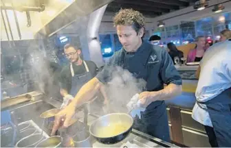  ?? MICHAEL LAUGHLIN/SOUTH FLORIDA SUN SENTINEL ?? Valentino Cucina Italiana chef and owner Giovanni Rocchio works the line on his last night cooking Wednesday.