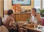  ?? ?? Above: Two Frenchmen enjoy lunch at an Italian restaurant in Shanghai. — Jiang Xiaowei