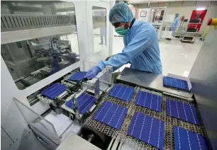  ?? — Reuters ?? An employee works at a solar cell production line at a Jupiter Solar Power Limited plant in Baddi, in the northern state of Himachal Pradesh.