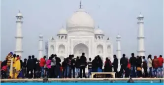  ?? — AFP photos ?? Crowds gather to visit the Taj Mahal in Agra yesterday.