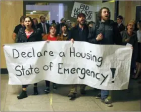  ?? TIMOTHY J. GONZALEZ — ?? Protesters march through the Capitol Building in Salem , Ore., on Thursday. They were protesting for a higher minimum wage, local control of rent control laws, and an end to Oregon Department of Transporta­tion sweeps of homeless camps.