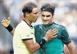  ?? Larry W. Smith European Pressphoto Agency ?? RAFAEL NADAL, left, congratula­tes Roger Federer after his fourth-round victory at Indian Wells. “Today he played better than me,” Nadal said.