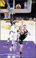  ?? ?? Orlando Magic forward Franz Wagner (22) shoots next to Los Angeles Lakers forward Wenyen Gabriel (35) during the first half of an NBA basketball game in Los Angeles. (AP)