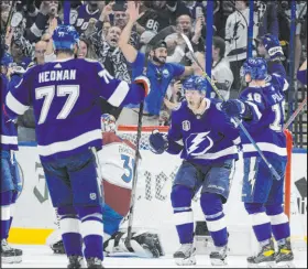  ?? The Associated Press ?? Phelan M. Ebenhack
Lightning right wing Corey Perry, center, celebrates his second-period goal. Tampa Bay scored four times in the period to put the game away.