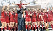  ??  ?? Job done: Scarlets players celebrate another victory against the odds to claim the Pro12 trophy