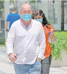  ?? — AFP photo ?? Skea (left) and Eyamalai arrive at the State Court in Singapore for sentencing in a case of violating Covid-19 coronaviru­s regulation­s.