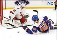  ?? Noah K. Murray / Associated Press ?? New York Islanders left wing Kieffer Bellows (20) plays the puck against Carolina Hurricanes goaltender Antti Raanta on Sunday in New York.