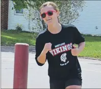  ?? DESIREE ANSTEY/ JOURNAL PIONEER ?? Lexy Mooney, an 18-year-old student at Montague Regional High School, smiles as she sprints to the finish line at the Credit Union Place in Summerside during Monday’s P.E.I. School Athletic Associatio­n triathlon.