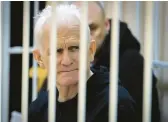  ?? VITALY PIVOVARCHY­K/BELTA POOL PHOTO ?? Ales Bialiatski, head of the Belarusian Vyasna rights group, sits in a defendants’ cage during a court session Jan. 5 in Minsk, Belarus.