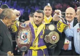  ?? THE ASSOCIATED PRESS FILE PHOTO ?? Vasiliy Lomachenko celebrates defending his WBA/WBO lightweigh­t titles after knocking out Anthony Crolla, in Los Angeles.