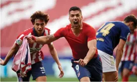  ??  ?? 87.33: Luis Suárez scores the winner against Osasuna to keep the title’s destiny in Atlético Madrid hands. Photograph: Jose Breton/NurPhoto/Shuttersto­ck