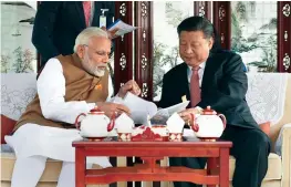  ?? — PTI ?? Prime Minister Narendra Modi with Chinese President Xi Jinping on a house boat at Wuhan’s East Lake in China on Saturday.