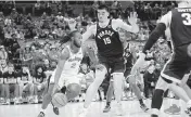  ?? ADAM CAIRNS Columbus Dispatch ?? Ohio State guard Bruce Thornton dribbles around Purdue center Zach Edey during the second half Sunday.