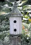  ??  ?? Bottom right: Bird feeders of all shapes are sprinkled throughout the backyard garden.