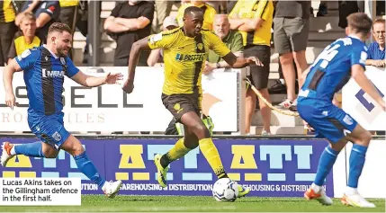  ??  ?? Lucas Akins takes on the Gillingham defence in the first half.