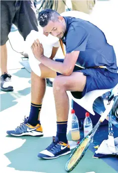  ??  ?? Nick Kyrgios of Australia takes a break during his men’s singles second round match against Pierre-Hugues Herbert of France. — AFP photo