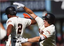  ?? PHOTO BY JASON O. WATSON — GETTY IMAGES ?? Nick Hundley, right, celebrates with Denard Span after hitting knocking in the gamewinnin­g run for the Giants in the 12th inning Saturday.