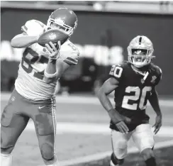  ?? ISAAC BREKKEN/ASSOCIATED PRESS ?? Chiefs tight end Travis Kelce catches the winning touchdown pass Sunday night as the Raiders’ Damon Arnette can’t stop him.