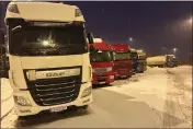  ?? KARL RITTER — THE ASSOCIATED PRESS ?? Ukrainian truck drivers wait to cross from Poland back into Ukraine in Korczowa, Poland, on Thursday.