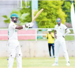  ?? LENNOX ALDRED PHOTO ?? Jamaica Scorpions wicket-keeper batsman Romaine Morris raises his bat after scoring a half-century against the Windward Islands Volcanoes during their West Indies Championsh­ip encounter at Sabina Park yesterday.