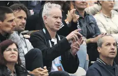  ?? JULIAN FINNEY / GETTY IMAGES ?? John McEnroe watches the action during the men’s singles fourth round match on Sunday.