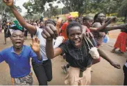  ?? Ben Curtis / Associated Press ?? Supporters of opposition leader Raila Odinga celebrate after hearing the verdict in Nairobi.