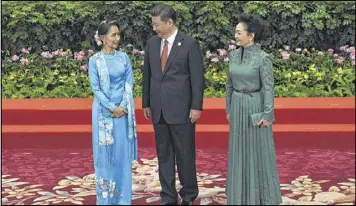  ?? WANG ZHAO / AP ?? Myanmar’s State Counsellor Aung San Suu Kyi (left) talks with Chinese President Xi Jinping and his wife Peng Liyuan during a welcome ceremony for leaders attending the Belt and Road Forum at the Great Hall of the People in Beijing on Sunday.