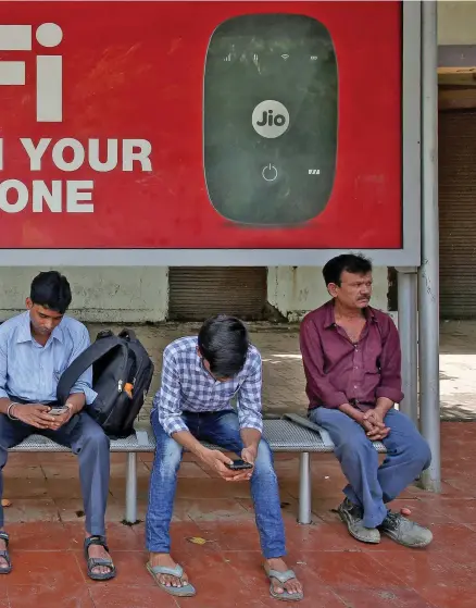  ?? Reuters ?? A billboard for Reliance Industries’ Jio. The company chairman, Mukesh Ambani, announced the launch of a new 4G phone at its recent AGM