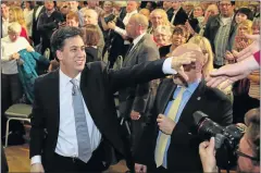  ??  ?? CAMPAIGN TRAIL: Labour leader Ed Miliband reaches out to shake supporters after speaking at a rally in Kempston before today’s polls
the
hands
of