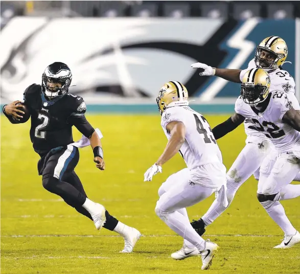  ?? DERIKHAMIL­TON/AP ?? The Eagles’Jalen Hurts scrambles against the Saints on Sunday in Philadelph­ia.