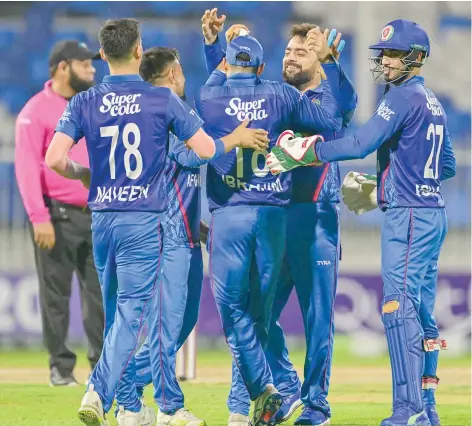  ?? — AFP ?? Afghanista­n’s players celebrate winning the third Twenty20 match against Ireland at the Sharjah Cricket Stadium in Sharjah.