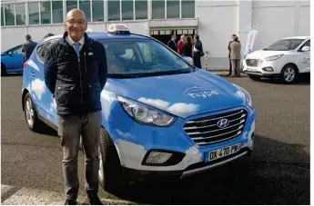  ??  ?? Abdou Aacha de la Société des taxis électrique­s parisiens présente son taxi à hydrogène.