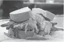  ?? BRUCE DEACHMAN ?? Pittsburgh’s Primanti Bros. restaurant is famous for its sandwiches with coleslaw, meat and french fries. They’ve been making them like that for more than 80 years.