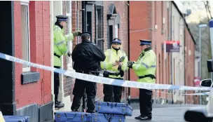  ??  ?? ●●Police officers outside the house on Clement Royd Street where the woman was found dead