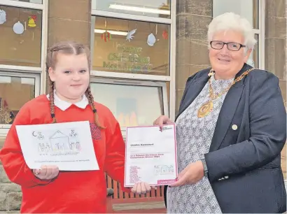  ?? ?? Brilliant designs Charlize Carmichael, one of the winning pupils, with Provost Jean Jones