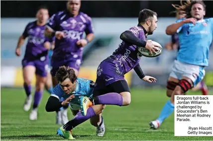  ?? Ryan Hiscott Getty Images ?? Dragons full-back Jordan Williams is challenged by Gloucester’s Ben Meehan at Rodney Parade.