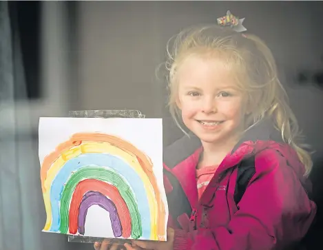  ??  ?? Poppy Stephenson, 3, putting a rainbow in the window.