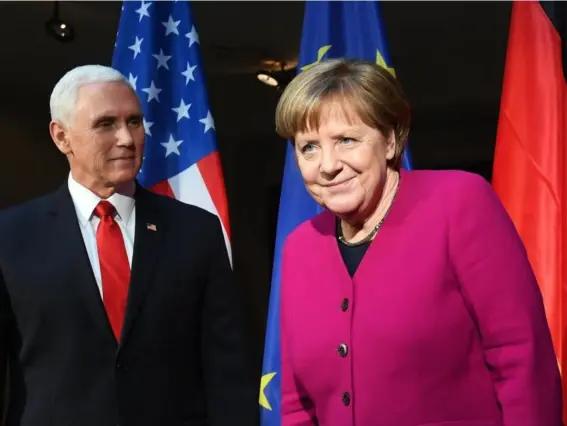  ??  ?? Tensions: Mike Pence and Angela Merkel in Munich on Saturday (AFP/Getty)