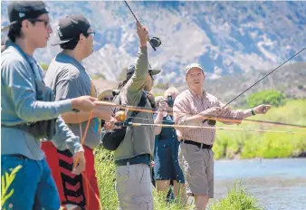  ?? EDDIE MOORE/JOURNAL ?? U.S. Sen. Tom Udall fishes with people from the Kewa Pueblo on the Rio Grande in the Orilla Verde Recreation Area in July 2017.